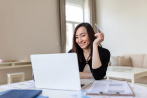 portrait-smile-beautiful-business-asian-woman-working-office-desk-virtual-computer